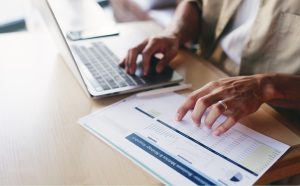 OCR limitations: manually cross-checking a printed data report against a laptop due to scanning errors.